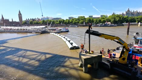 barges maneuvering on the river thames