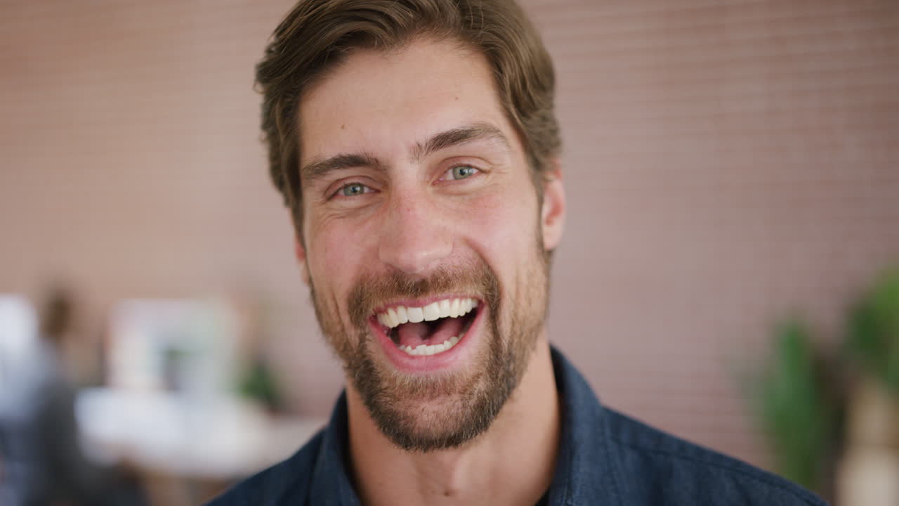 close up portrait of attractive young man laughing happy entrepreneur enjoying success slow motion