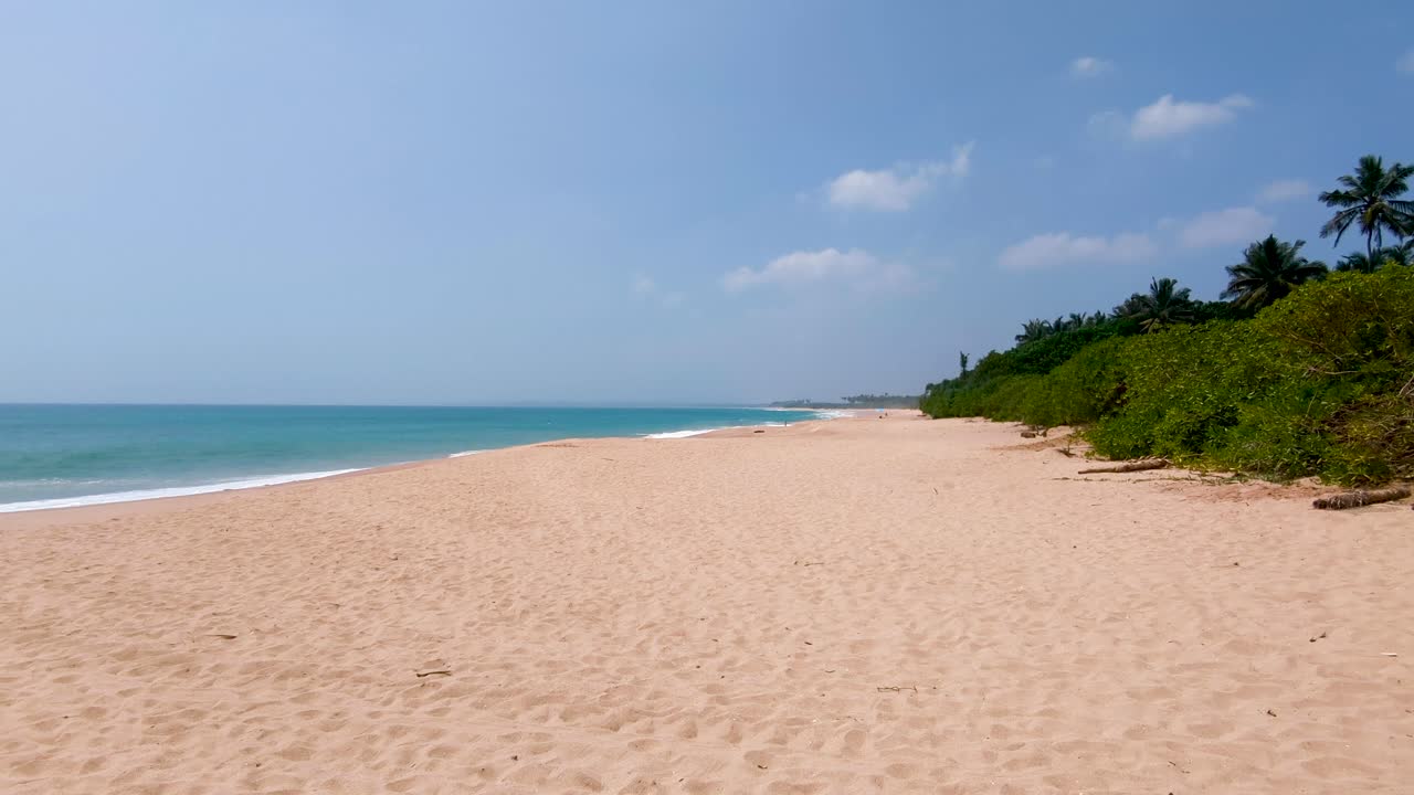 Pristine stretch of white sandy beach with blue ocean water at Rekawa Beach Southern Province Sri Lanka