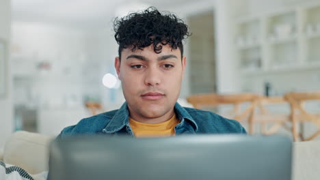 man typing on laptop in home