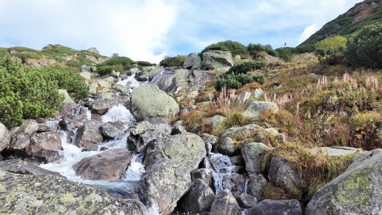 Mountain waterfall seen from the lower perspective. Tatra Mountains.