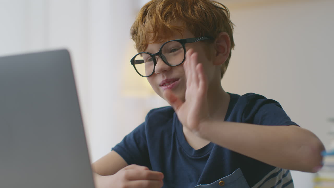 Boy Video Conferencing on Laptop
