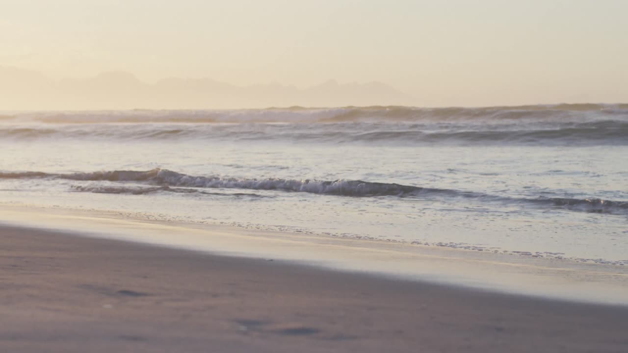 Sea with waves and blue sky on sunny beach