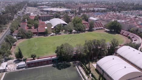 drone aerial view of soccer stadium in mexico city with players on the field