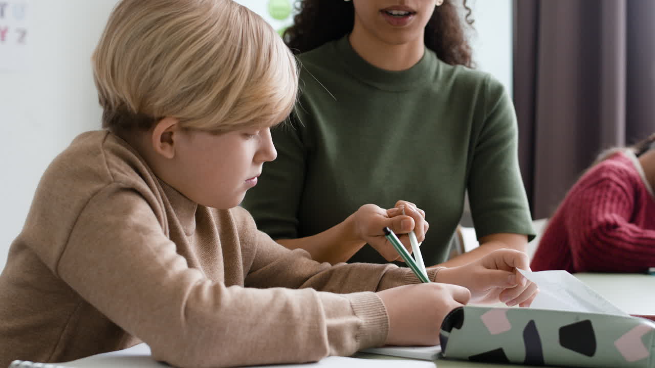 Student getting help with homework in class