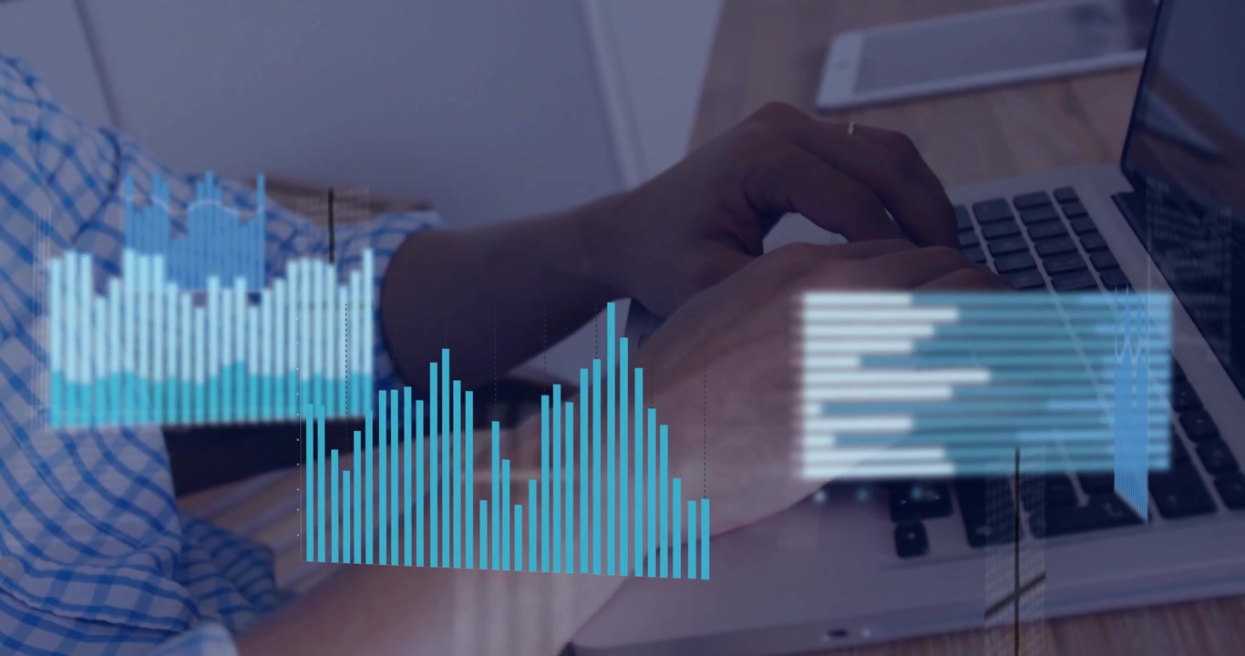Man typing on laptop keyboard generating business bar charts rotating and animating month data