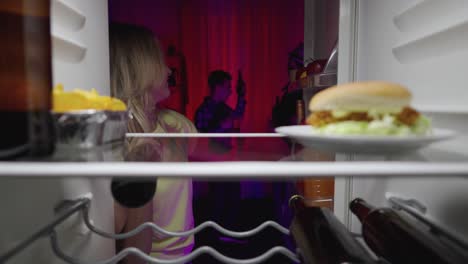 friends partying inside, food on the fridge