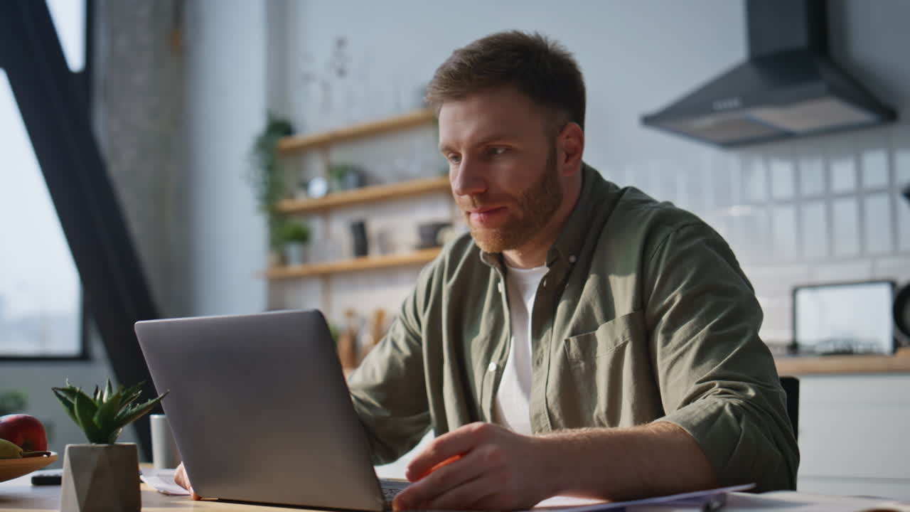 Smiling entrepreneur video meeting looking laptop web camera in kitchen closeup