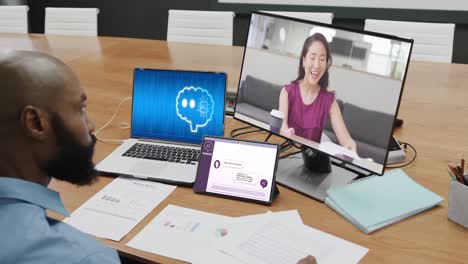 Diverse-business-people-on-computer-video-call-with-data-processing-on-laptop-in-office