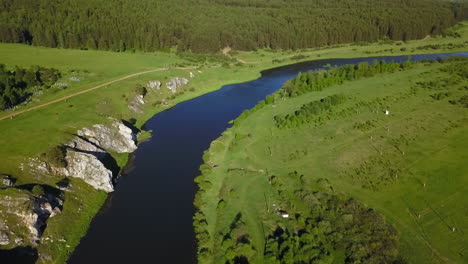 aerial view of a river valley with lush green landscape and forest