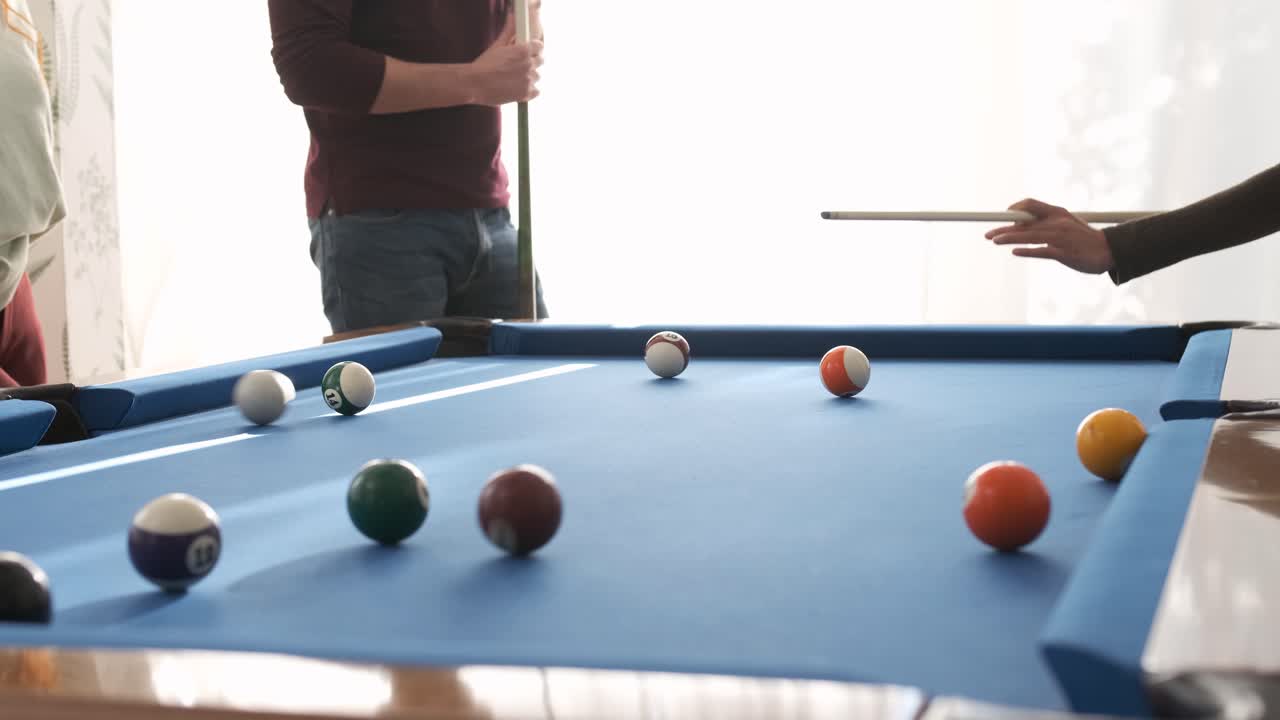 Unrecognizable woman playing pool in game room on weekend