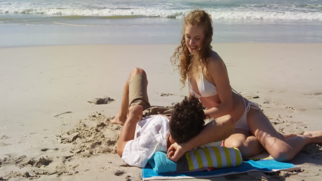 pareja relajándose juntos en la playa 4k