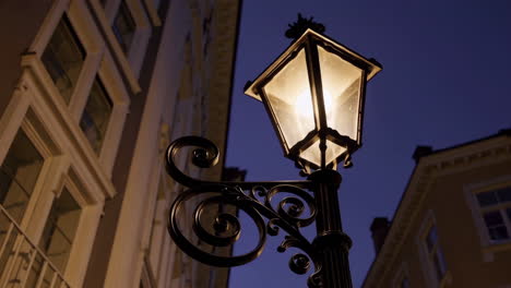 ornate street lamp illuminated at twilight