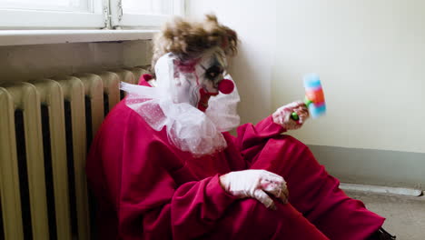 crazy clown sitting on the floor