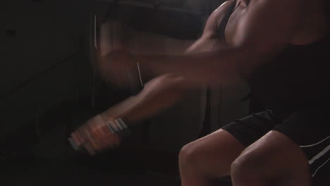 Close-Up-Studio-Shot-Of-Male-Athlete-Training-In-Fitness-Vest-Using-Battle-Ropes-Shot-Against-Black-Background-3