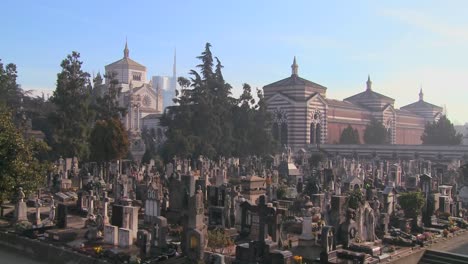 the modern skyline of milan italy with a vast cemetery foreground