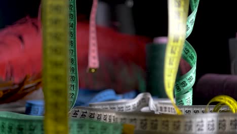 tape measure hang black bacground dolly slide slow motion