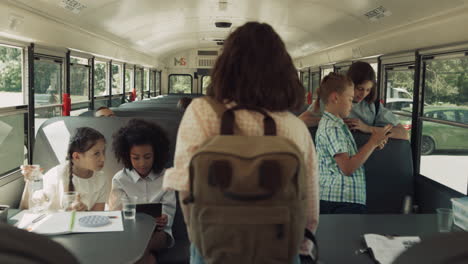 alumnos adolescentes subiendo al autobús escolar. niños diversos usando aparatos en el vehículo.