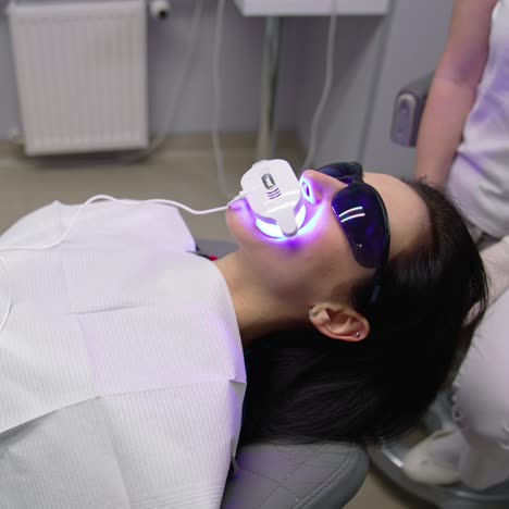 dentist treats oral cavity. young female patient visiting dentist office