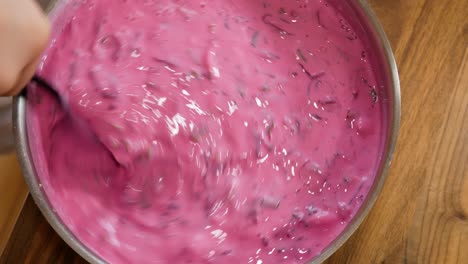 mixing freshly made beetroot soup in stainless steel bowl