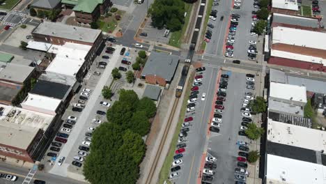 Time-lapse-of-a-train-moving-through-a-small-towns-downtown-area