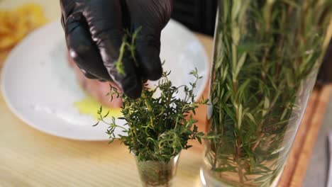 preparing a steak with rosemary and thyme