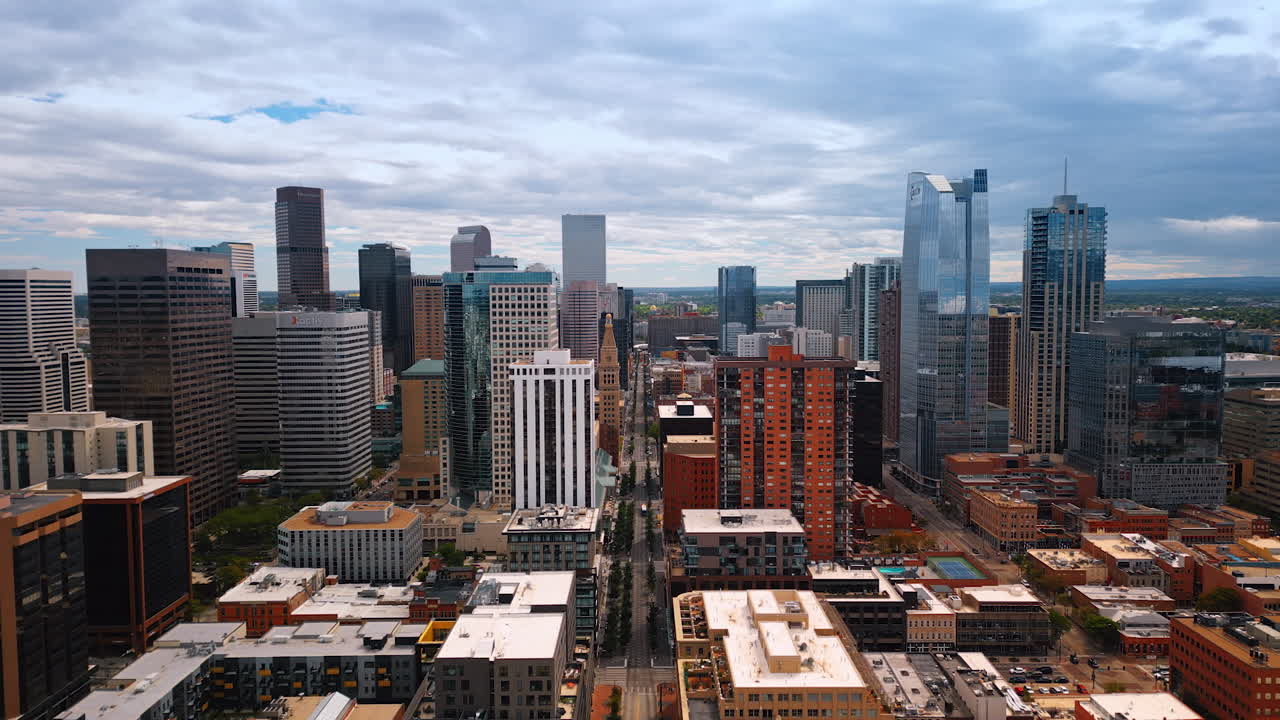 Denver, USA, 24 August 2025: Moving over the long straight street along the high-rises. Modern urban landscape of Denver, Colorado, USA from drone