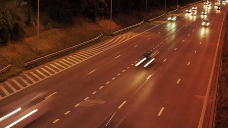 a cinematic timelapse of a highway at night with moving car headlights and subtle anamorphic flares