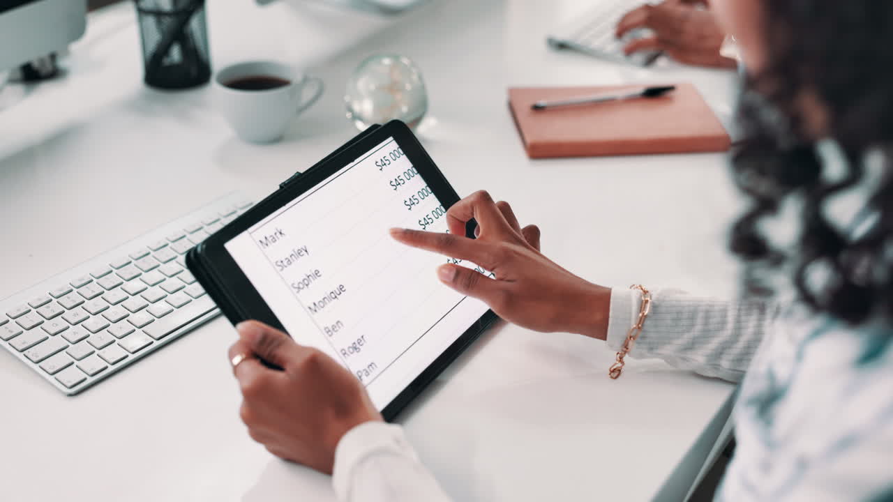 Businesswoman analyzing sales report on tablet