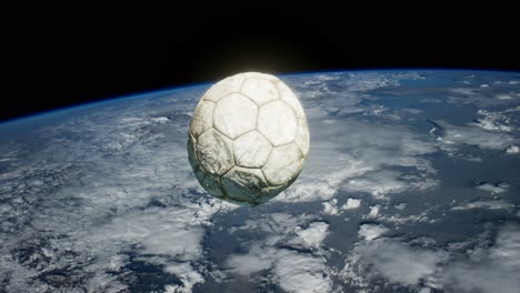 old soccer ball in space on earth orbit