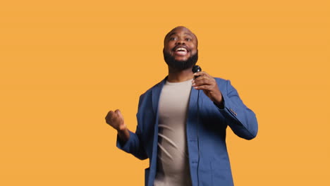 motivational speaker holding monologue using microphone, studio background