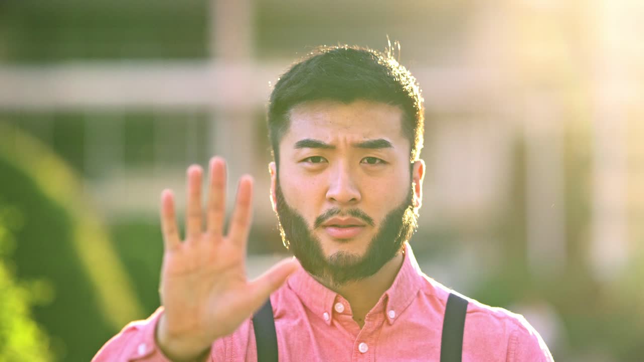 Young man making a stop gesture with his hand