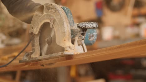 cutting a plank, lumber with a circular saw, close up view