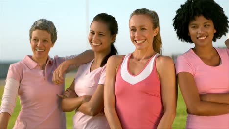 smiling women wearing pink for breast cancer