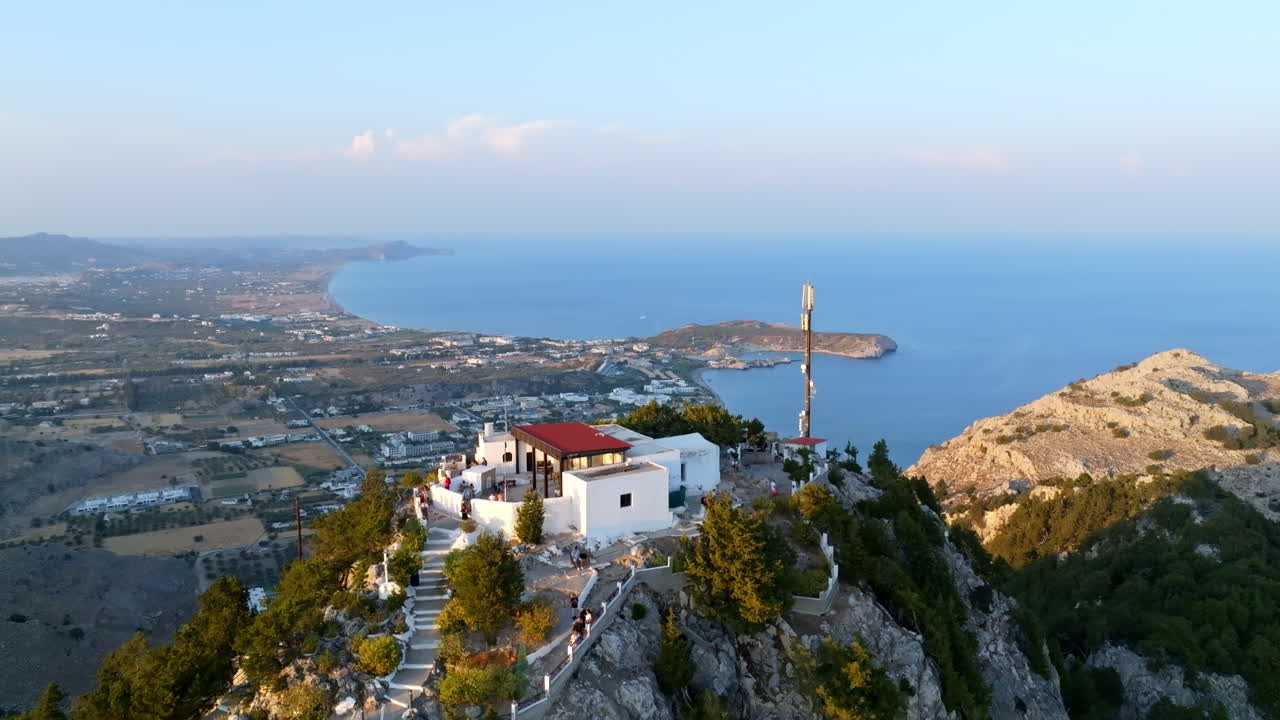Aerial ascending shot in front of Tsambika Monastery, revealing Kolympia, Rhodes