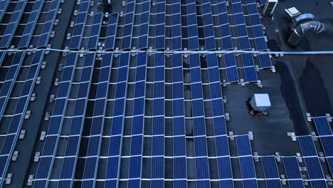the drone shot of solar panels on the roof of industrial building