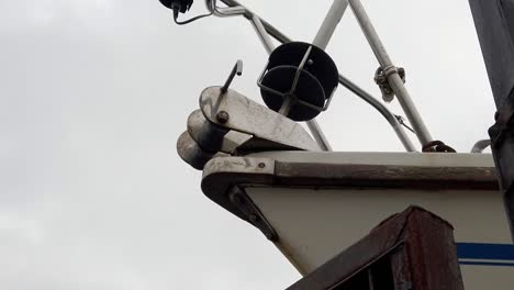 under sailing ship bow metal tackle winch hoist closeup in shipyard