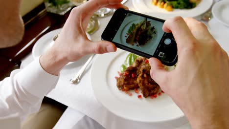 businessman taking photo of meal with mobile phone 4k