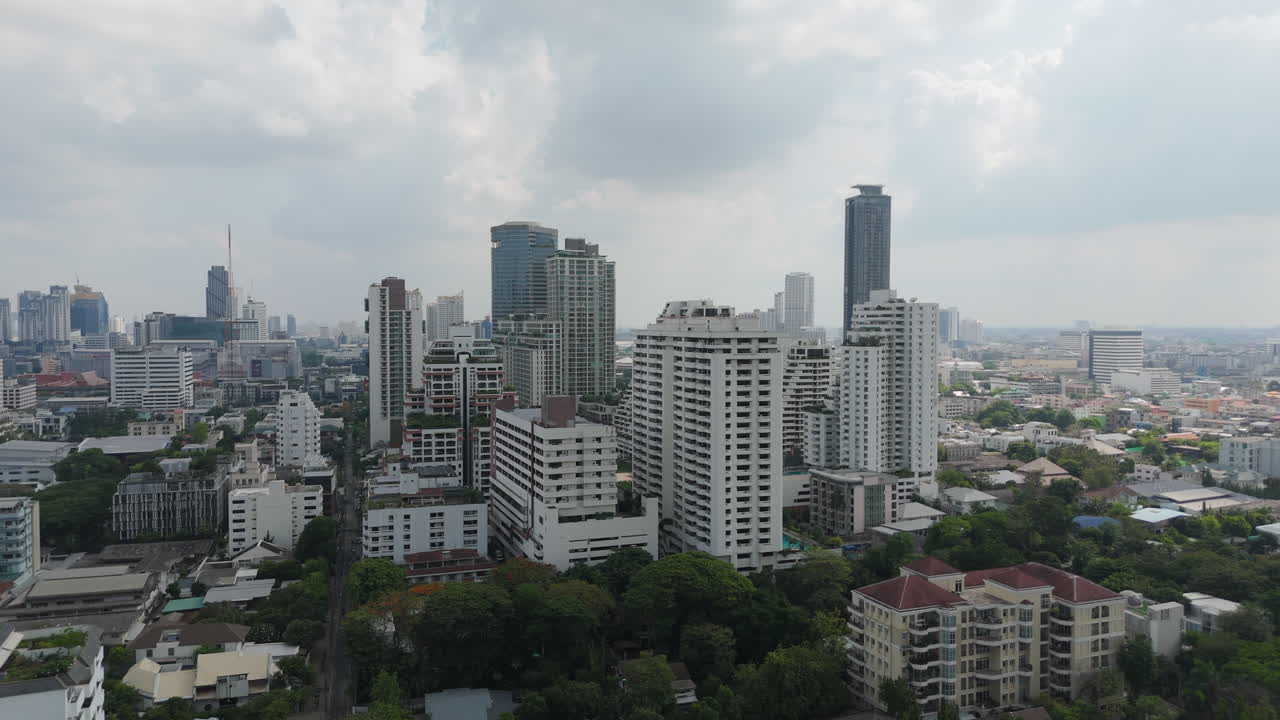 Buildings Rise On The Urban Landscape Of Phrom Phong Area In Bangkok, Thailand. Aerial Drone Shot