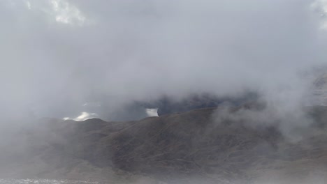 Slow-panning-shot-from-Ben-Lomond-looking-over-Loch-Lomond-under-heavy-fog