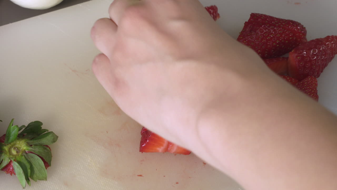 Cutting A Delicious And Fresh Red Strawberries On A Chopping Board. - close up shot