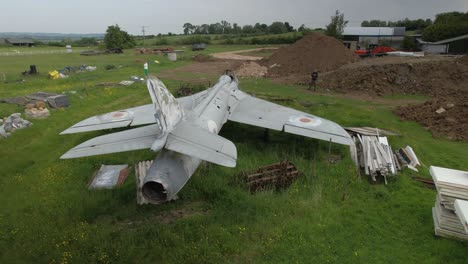 rear aerial view behind hawker hunter abandoned wt804 fighter jet among discarded junk in british field