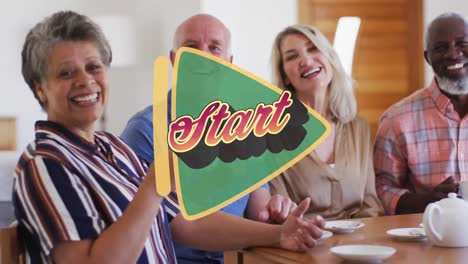 Start-text-over-triangle-banner-against-two-senior-diverse-couples-having-coffee-together-at-home