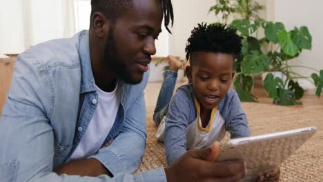 Father and son using technology together at home