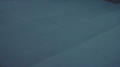 persona caminando en un piso gris con zapatos rojos