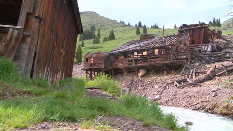 a traveling shot moves along a ghost town and river