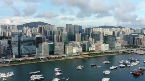 Hong-Kong-marina-with-anchored-boats-and-Kwun-Tong-area-buildings,-Aerial-view