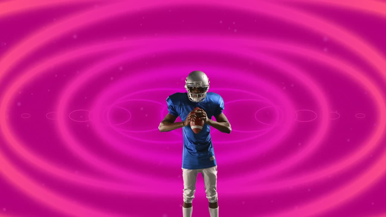 Jogador de rugby afro-americano segurando bola de rugby contra formas circulares em padrão contínuo