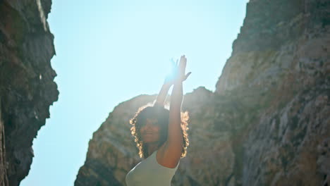 sun shining sporty woman practicing yoga on ursa beach close up. girl exercising