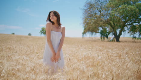 sensual model posing sun harvested land horizon. tender rural girl touching skin